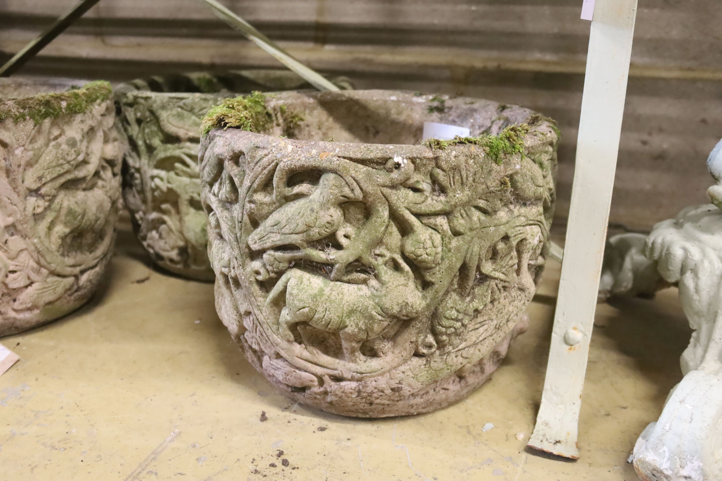 A set of four circular reconstituted stone garden planters, 30cm diameter, height 24cm